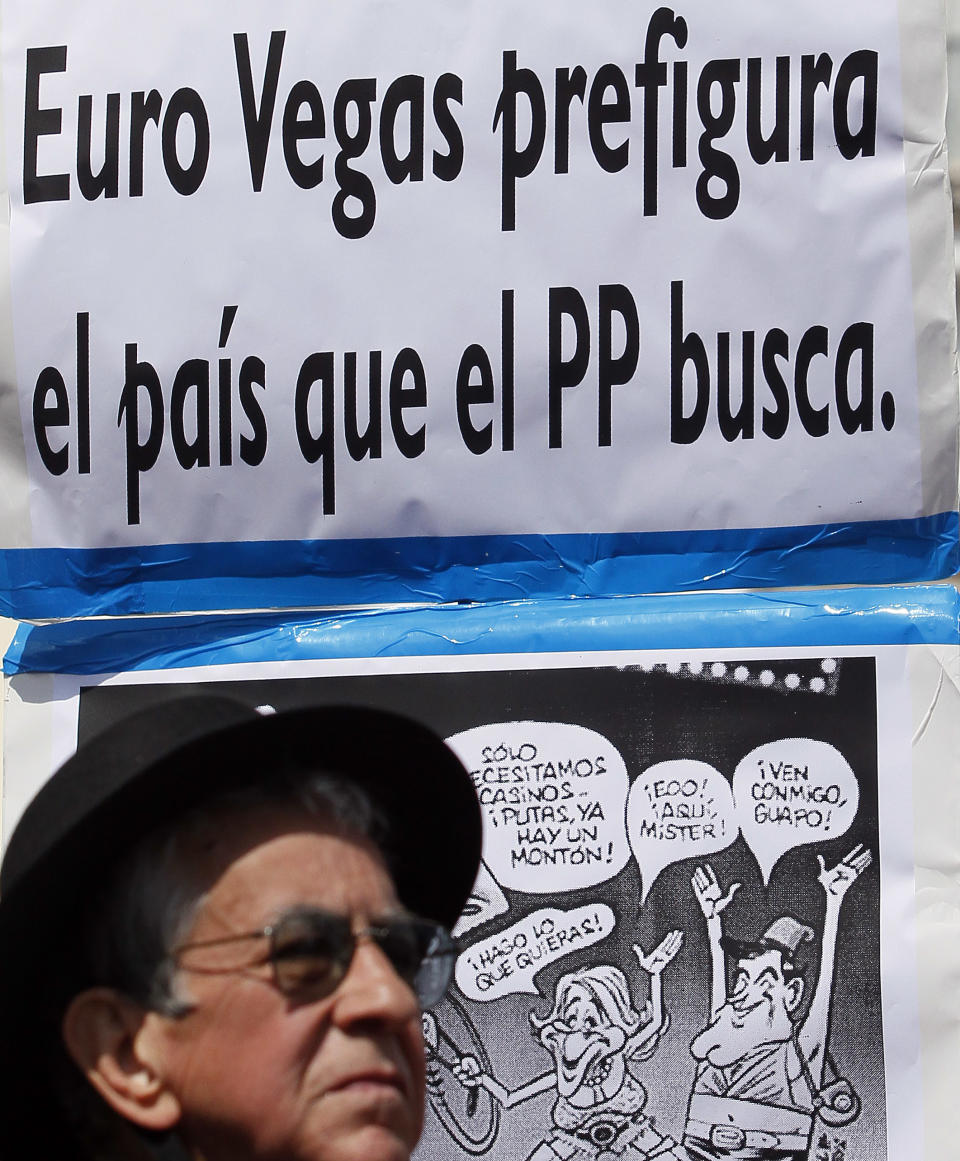 Men protest against a development project in Madrid, Spain, Saturday, March 17, 2012. Poster reads "Euro Vegas foreshadows the country that the PP seeks", referring to the ruling Popular Party, and a comic reding "we only need casinos, prostitutes we have a lot", "Come with me", "here mister", "I do what ever you want". Eurovegas is a U.S. billionaire's proposal that promises to build six casinos, 12 hotels and create jobs in a country on the brink of its second recession in four years and an unemployment rate near 23%. Madrid has been selected by Sheldon Adelson, 78, and his company Las Vegas Sands to be the site of Eurovegas, a project which protesters said would cost Spain more in grants, concessions and problems than it would yield benefits. (AP Photo/Andres Kudacki)