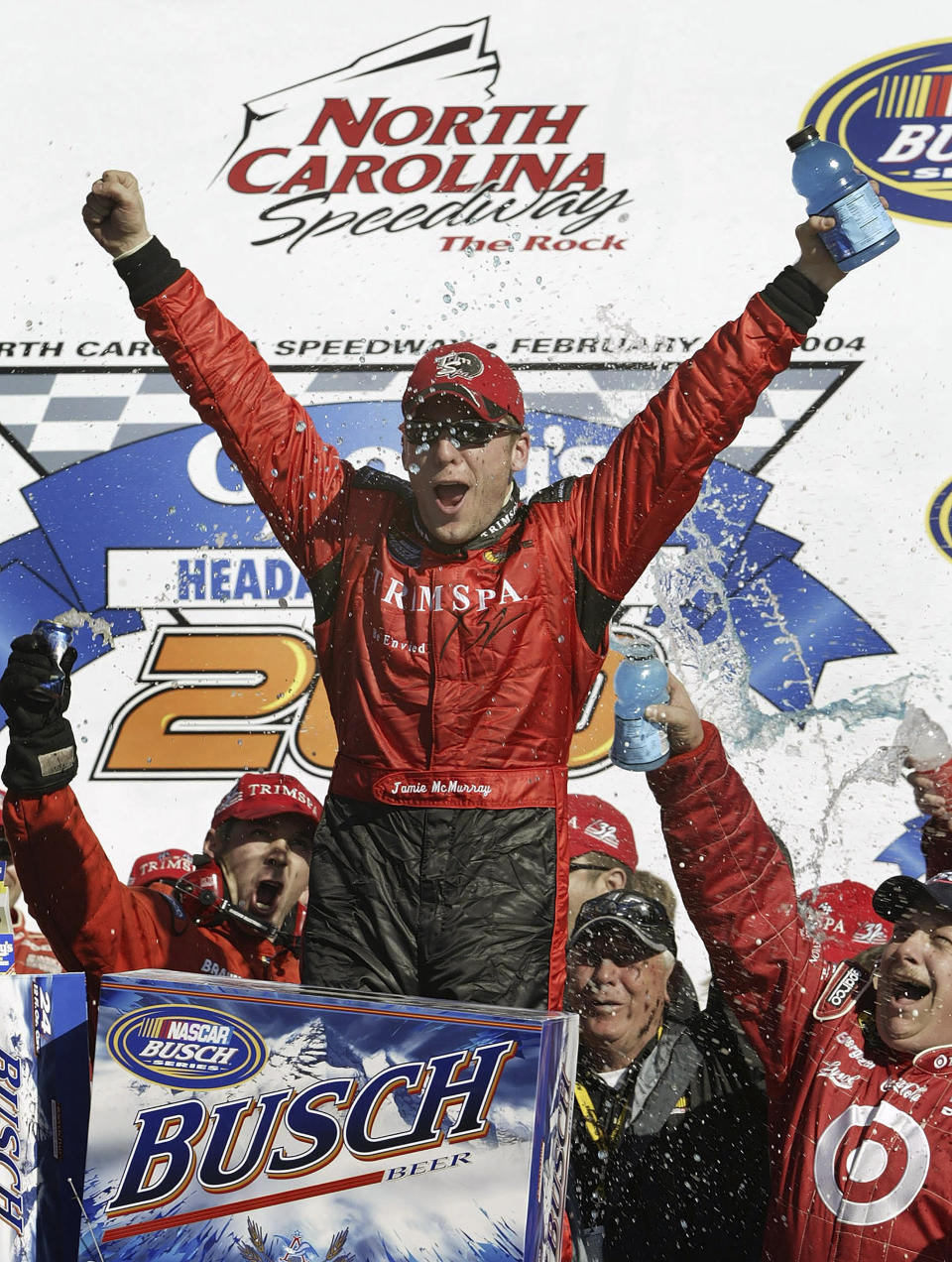 FILE - Jamie McMurray celebrates with his crew in Victory Lane after winning the NASCAR Busch Series auto race at North Carolina Speedway near Rockingham, N.C., Feb. 21, 2004. Rockingham is a rural track that lost its place on the NASCAR schedule as the sport gravitated toward larger and more profitable markets. (AP Photo/Chuck Burton, File)
