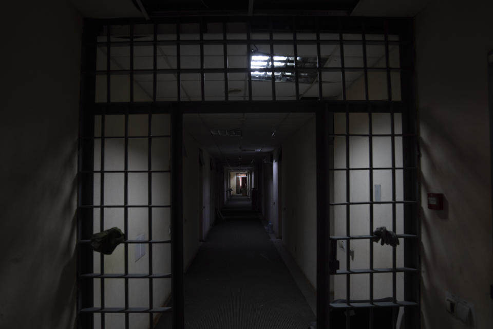 Light streams through a hole in the ceiling of a jail in which Ukrainians civilians said the were tortured by Russian forces, in Kherson, Ukraine, Thursday, Dec. 8, 2022. (AP Photo/Evgeniy Maloletka)