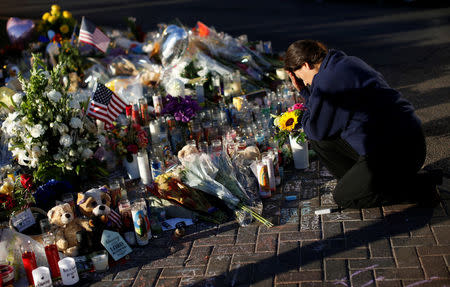 A woman pauses at a makeshift memorial in the middle of Las Vegas Boulevard following the mass shooting in Las Vegas, Nevada, U.S., October 6, 2017. REUTERS/Chris Wattie