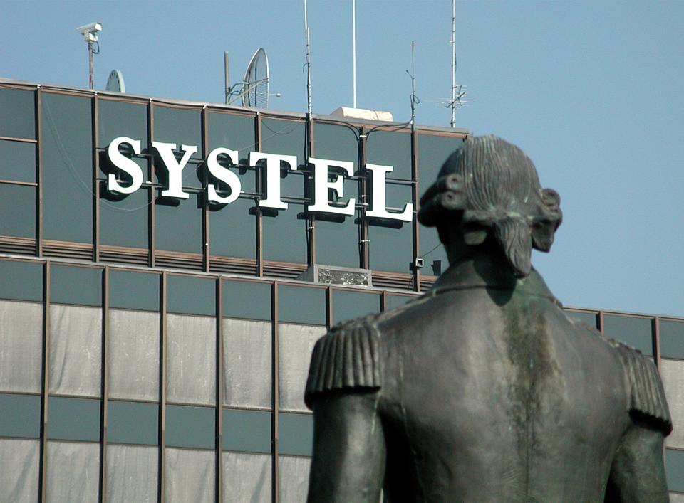 The statue of Marquis de Lafayette faces westward toward the Systel Building,  downtown Fayetteville's tallest building, on June 29, 2003.