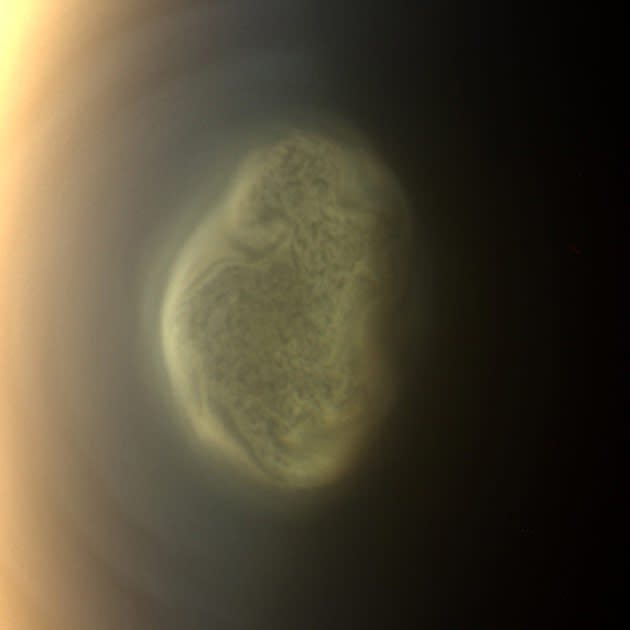 A true color image of Titan's colorful south polar vortex captured by NASA's Cassini spacecraft before a distant flyby of Saturn's moon Titan on June 27, 2012, shows a south polar vortex, or a mass of swirling gas, around the pole in the atmosphere of the moon. The south pole of Titan which is 3,200 miles (5,150 km) across is near the center of the view. The formation of the vortex at Titan's south pole may be related to the coming southern winter and the start of what will be a south polar hood. These new, more detailed images are only possible because of Cassini's newly inclined orbits, which are the next phase of Cassini Solstice Mission. Previously, Cassini was orbiting in the equatorial plane of the planet, and the imaging team's images of the polar vortex between late March and mid-May were taken from over Titan's equator. Scientists think these new images show open cell convection. In open cells, air sinks in the center of the cell and rises at the edge, forming clouds at cell edges. REUTERS/NASA/JPL-Caltech/Space Science Institute/Handout