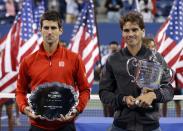 Rafael Nadal of Spain poses with his trophy after defeating Novak Djokovic of Serbia (L, with runner up trophy) in their men's final match at the U.S. Open tennis championships in New York, September 9, 2013.