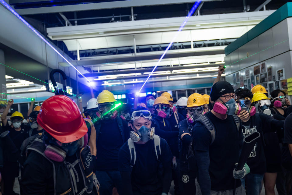 HONG KONG, CHINA - AUGUST 21: Protestors shine laser pointers during a protest at the Yuen Long MTR station on August 21, 2019 in Hong Kong, China. Pro-democracy protesters have continued rallies on the streets of Hong Kong against a controversial extradition bill since 9 June as the city plunged into crisis after waves of demonstrations and several violent clashes. Hong Kong's Chief Executive Carrie Lam apologized for introducing the bill and declared it "dead", however protesters have continued to draw large crowds with demands for Lam's resignation and completely withdraw the bill. (Photo by Billy H.C. Kwok/Getty Images)