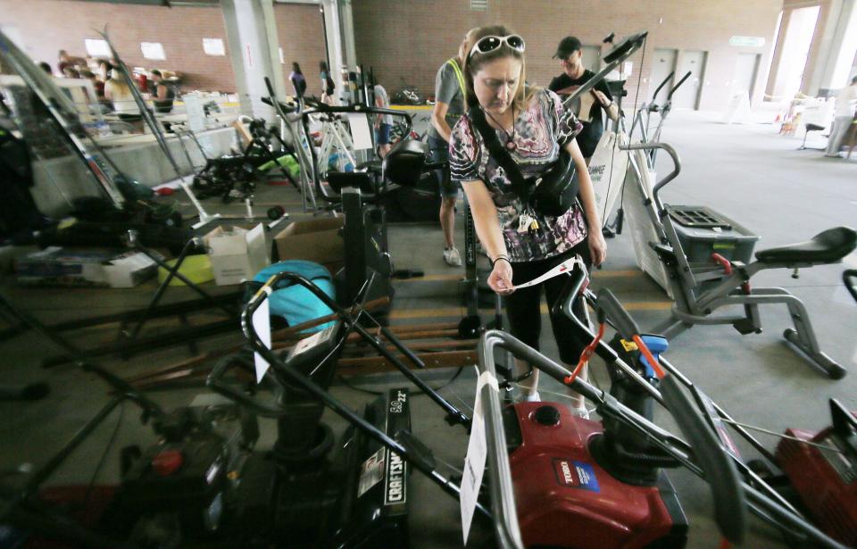 Brandi Wilson browses at the Rummage RAMPage, a week-long community garage sale designed to keep reusable items out of the waste stream, at Ames Intermodal Facility in Campustown on Monday, July 31, 2023, Ames, Iowa.