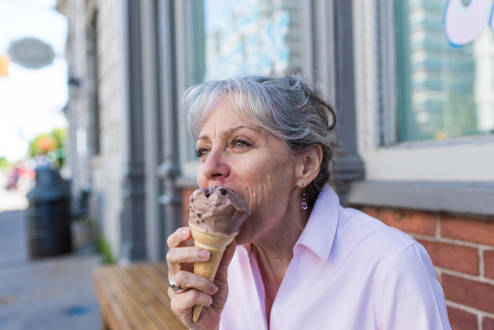 Woman enjoying an ice cream cone outside on a sunny day