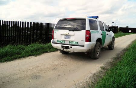 A Border Patrol vehicle is seen along the U.S. border fence in Brownsville, Texas, U.S. on November 17, 2016. REUTERS/Jon Herskovitz