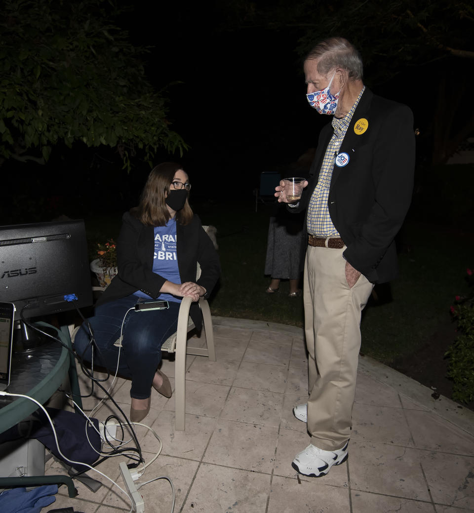 Transgender activist Sarah McBride, left, who hopes to win a seat in the Delaware Senate, talks with Sen. Harris McDowell, D-Wilmington North, at her primary night watch party, in Wilmington, Del., Tuesday, Sept. 15, 2020. (AP Photo/Jason Minto)