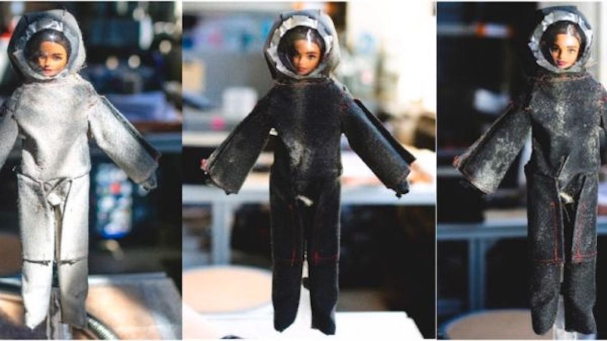  A trio of Barbie dolls wearing makeshift spacesuits.  