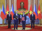 Philippine President Ferdinand Marcos Jr., left, and Vietnamese President Vo Van Thuong, right, look on as the Philippine Secretary for Foreign Affairs Enrique Manalo, second left, and Vietnamese Minister of Foreign Affairs Bui Thanh Son exchange signed documents in Hanoi, Vietnam Tuesday, Jan. 30, 2024. Marcos is on a visit to Hanoi to boost the bilateral relation with the fellow Southeast Asian nation. (Hoang Thong Nhat/VNA via AP)