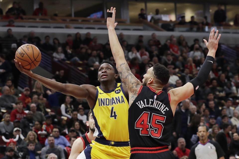 Indiana Pacers guard Victor Oladipo, left, drives to the basket as Chicago Bulls guard Denzel Valentine defends during the first half of an NBA basketball game in Chicago, Friday, March 6, 2020. (AP Photo/Nam Y. Huh)