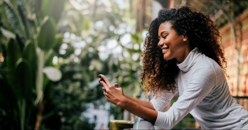 side view of beautiful woman using her phone indoors