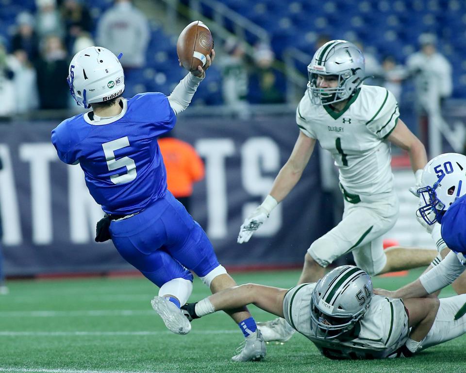 Scituate quarterback Henry Gates escapes the sack attempt of Duxbury’s Tindell Frick for a key completion on their drive in the fourth quarter of the Division 4 state title game at Gillette Stadium on Friday, Dec. 3, 2021.