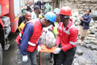 <p>Paramedics evacuate a man rescued from the rubble of a six-story building that collapsed after days of heavy rain, in Nairobi, Kenya, April 30, 2016. <i>(Photo: Stringer/Reuters)</i></p>