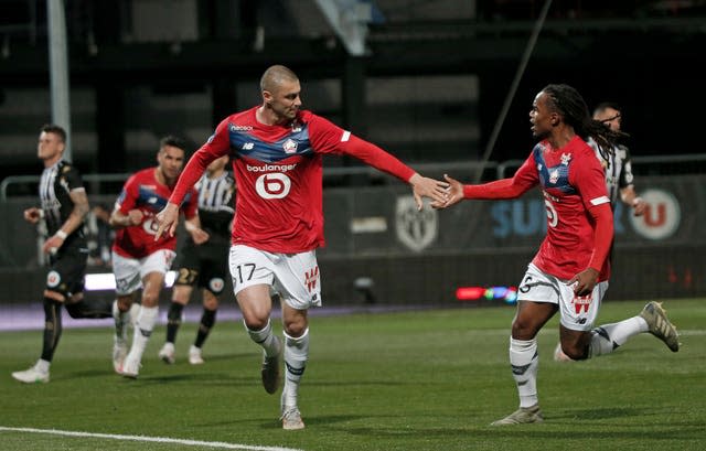 Burak Yilmaz and Renato Sanches celebrate during Lille's title-clinching victory at Angers in Ligue 1