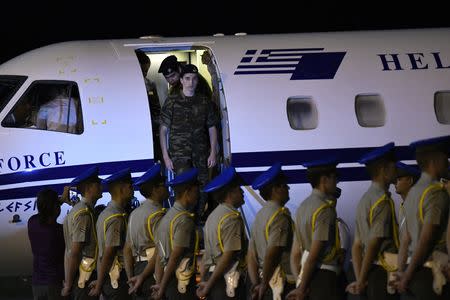 Angelos Mitretodis (front) and Dimitris Kouklatzis, two Greek soldiers who were detained in Turkey after crossing the border, exit the Greek Prime Minister's airplane after being released, at the airport of Thessaloniki, Greece, August 15, 2018. REUTERS/Alexandros Avramidis