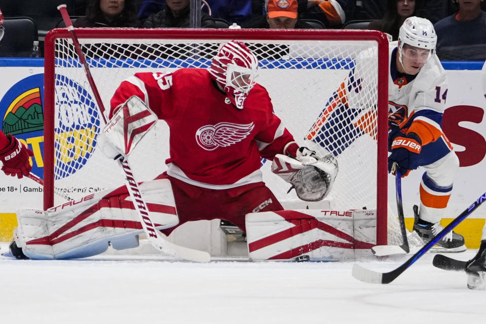 Detroit Red Wings goaltender Ville Husso (35) stops a shot on goal by New York Islanders' Bo Horvat (14) during the first period of an NHL hockey game Monday, Oct. 30, 2023, in Elmont, N.Y. (AP Photo/Frank Franklin II)