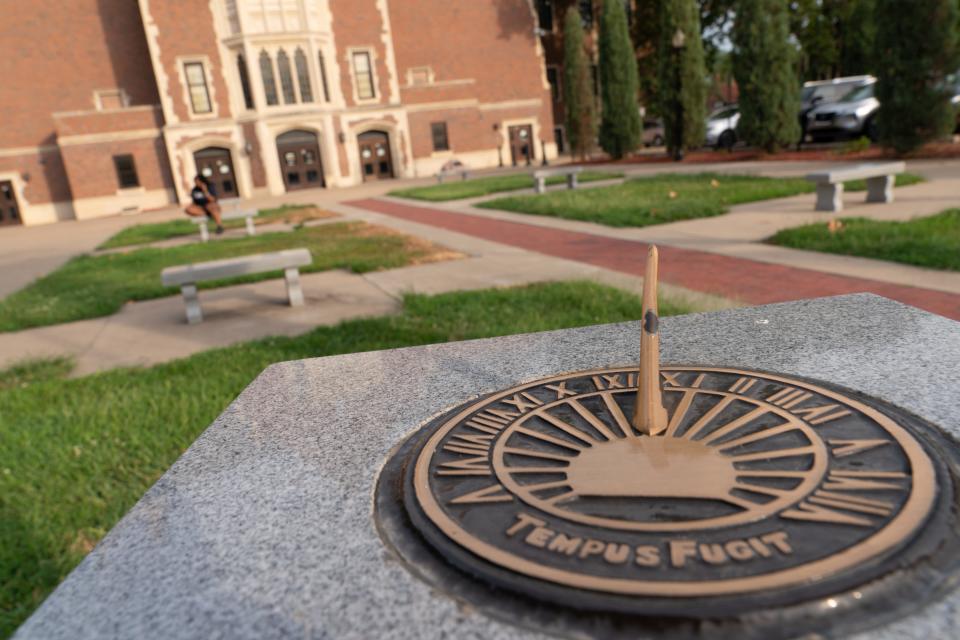 A sundial shows the early morning hour outside of Topeka High School.