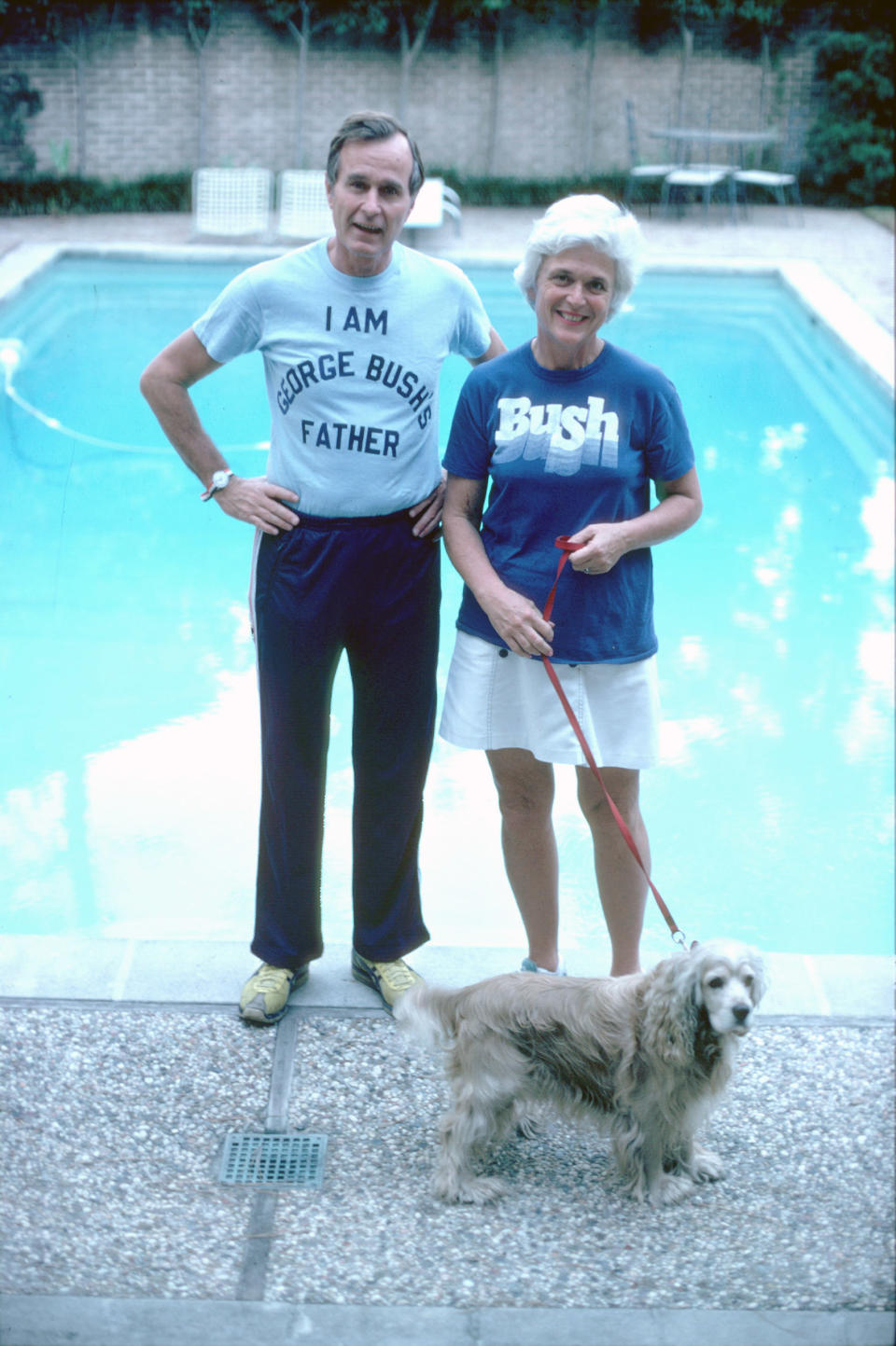 George H.W. Bush, wearing a t-shirt alluding to his son George W. Bush's run for Congress, stands with his wife Barbara in Nov. 1978.