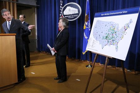 U.S. Deputy Attorney General James Cole (L) points to map of cleanup sites during an announcement of a settlement with Anadarko Petroleum Corp at the Justice Department in Washington April 3, 2014. REUTERS/Jonathan Ernst