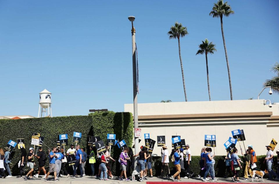 PHOTO: Striking SAG-AFTRA members picket as WGA (Writers Guild of America) members march in solidarity outside Paramount Studios on October 02, 2023 in Los Angeles, California. (Mario Tama/Getty Images)