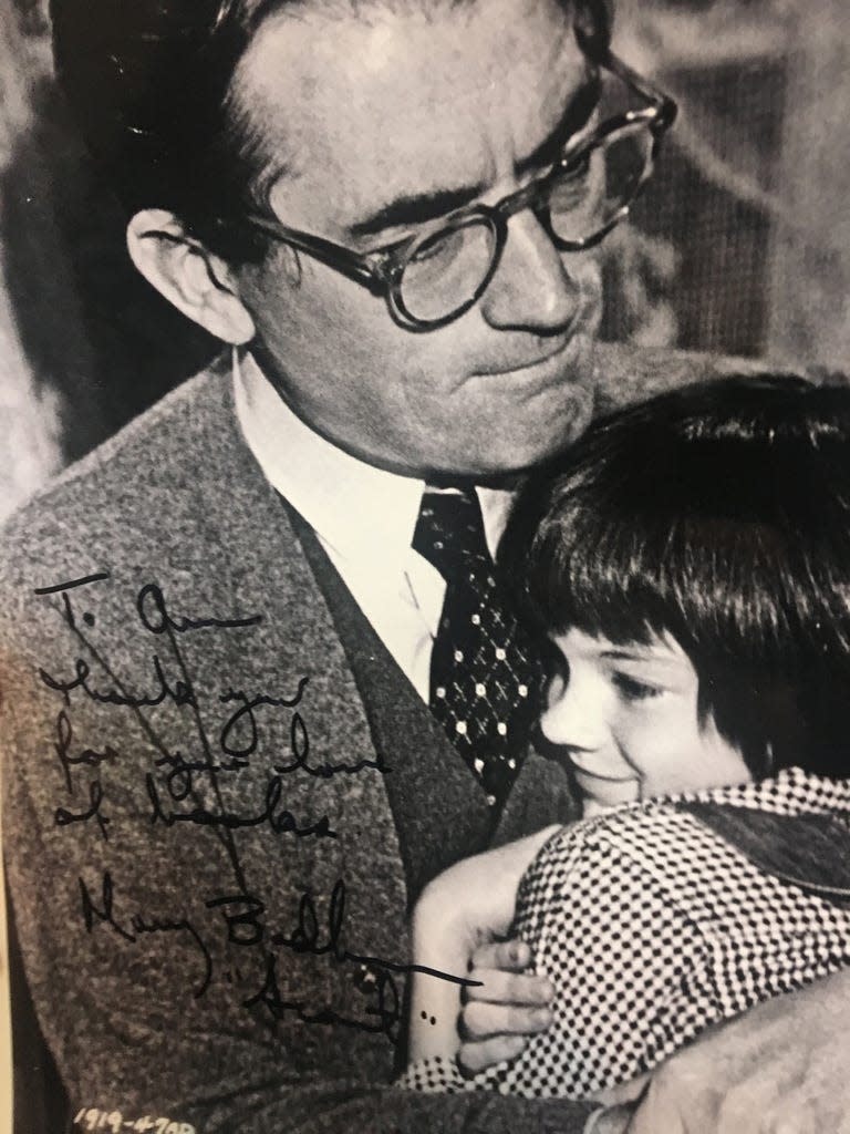 Gregory Peck, who portrayed Atticus Finch in “To Kill a Mockingbird,” hugs Birmingham-born Mary Badham, who played Scout.