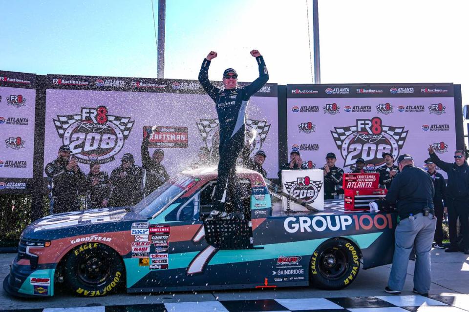 NASCAR veteran Kyle Busch celebrates in victory lane after winning the Craftsman Truck Series’ Fr8 208 at Atlanta Motor Speedway on Saturday.