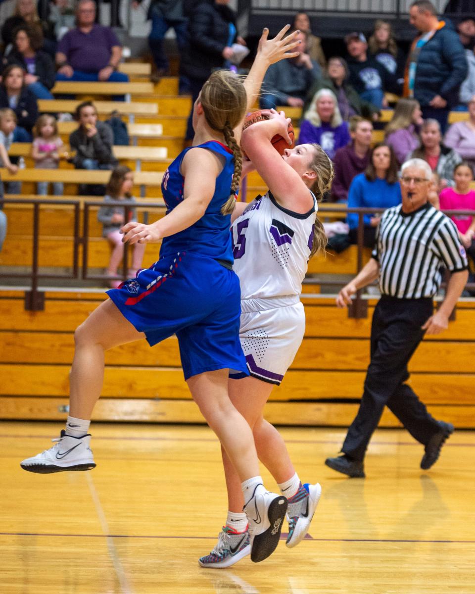 Chase Gilpin of Southeast of Saline (45) goes up strong against a Republic County defender Tuesday in the Trojans' 63-12 home victory. 