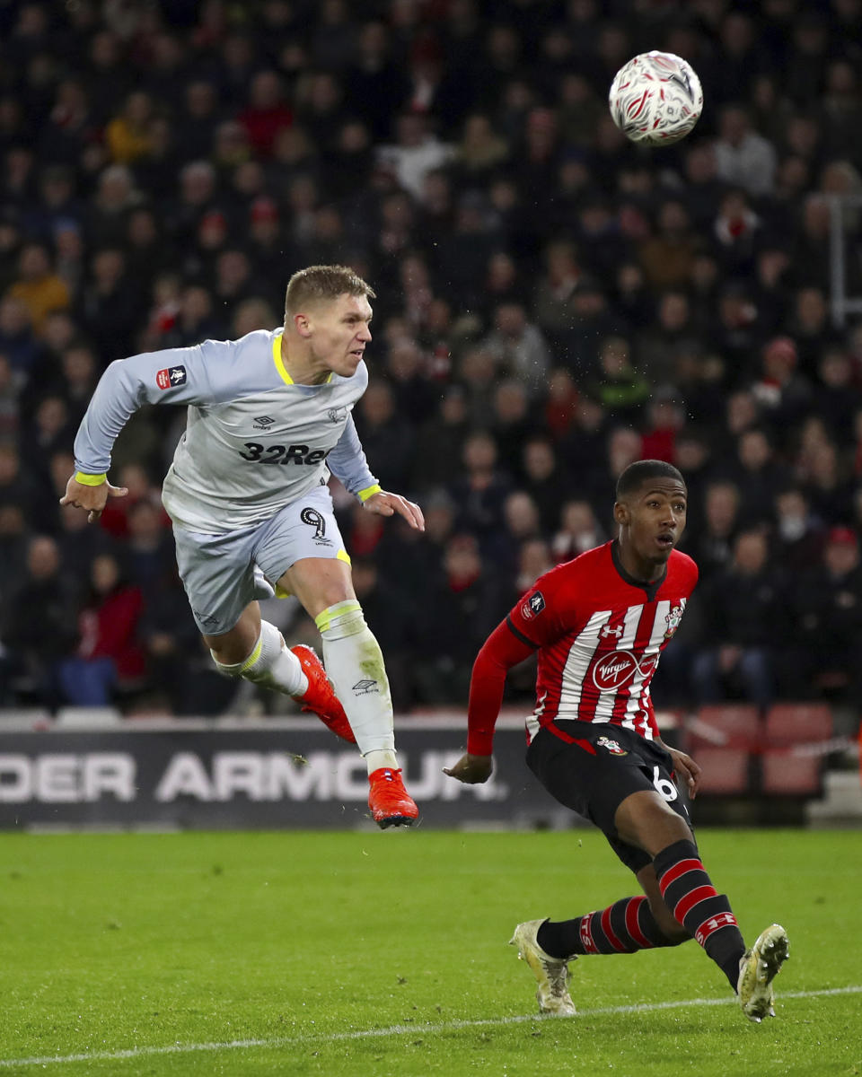 Derby County's Martyn Waghorn, left, celebrates scoring his side's second goal of the game against Southampton, during their English FA Cup third round replay soccer match at St Mary's Stadium in Southampton, England, Wednesday Jan. 16, 2019. (Nick Potts/PA via AP)