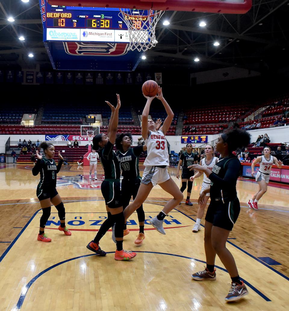 Bedford's Victoria Gray is tripled teamed by Indya Davis, Sheridan Beal and Kendall Hendrix of West Bloomfield during a 54-32 Bedford loss in the Division 1 state quarterfinals at the University of Detroit's Mercy Calihan Hall on Tuesday, March 19, 2024.