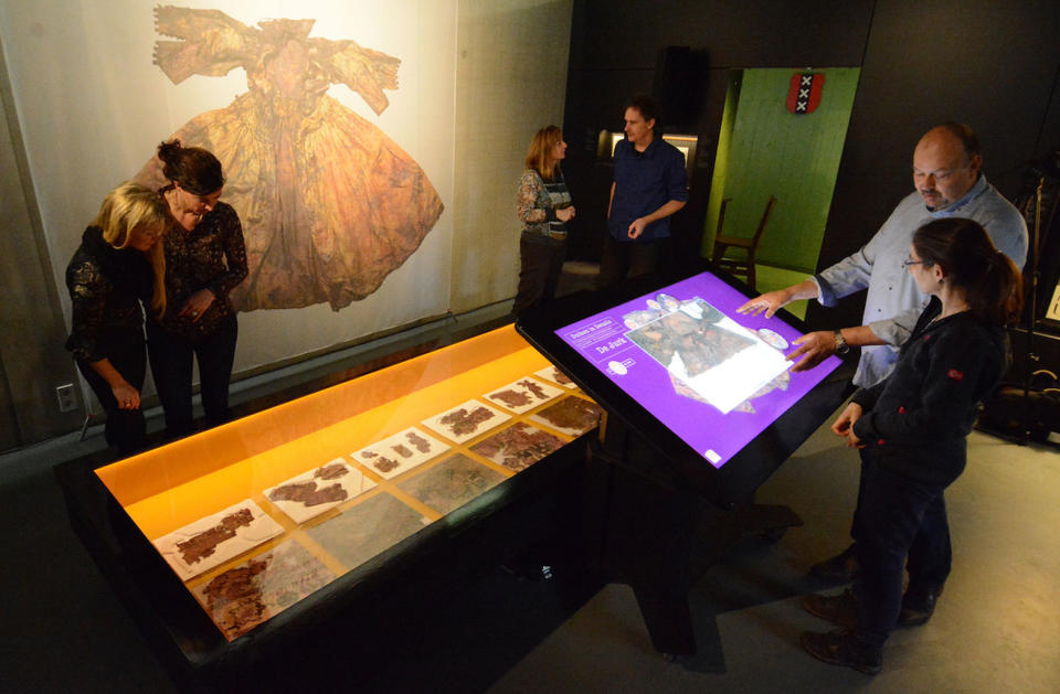 A preserved silk dress and fragments of a 17th-century carpet, both found on the Palmwood shipwreck, are on display as part of the exhibition called "Diving into Details" at the Kaap Skil museum in the Netherlands until mid-February. <cite>Kaap Skil museum</cite>