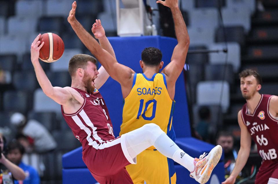 Latvia’s Davis Bertans (L) vies for a ball with Brazil’s Tim Soares (C) as Latvia’s Kristers Zoriks looks on during the FIBA Basketball World Cup second round group J game at Indonesia Arena in Jakarta on September 3, 2023. (Photo by ADEK BERRY / AFP) (Photo by ADEK BERRY/AFP via Getty Images)