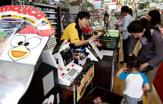 Shoppers line up in front of cashiers at the Don Quijote’s central branch store in Tokyo May 28, 2014. (Photo: REUTERS/Yuya Shino)