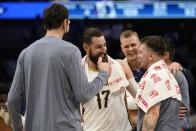 Dallas Mavericks' Boban Marjanovic, left front, New Orleans Pelicans' Jonas Valanciunas (17), Mavericks' Kristaps Porzingis, center rear, and Mavericks' Luka Doncic, front right, talk after their NBA basketball game in Dallas, Monday, Nov. 8, 2021. (AP Photo/Tony Gutierrez)