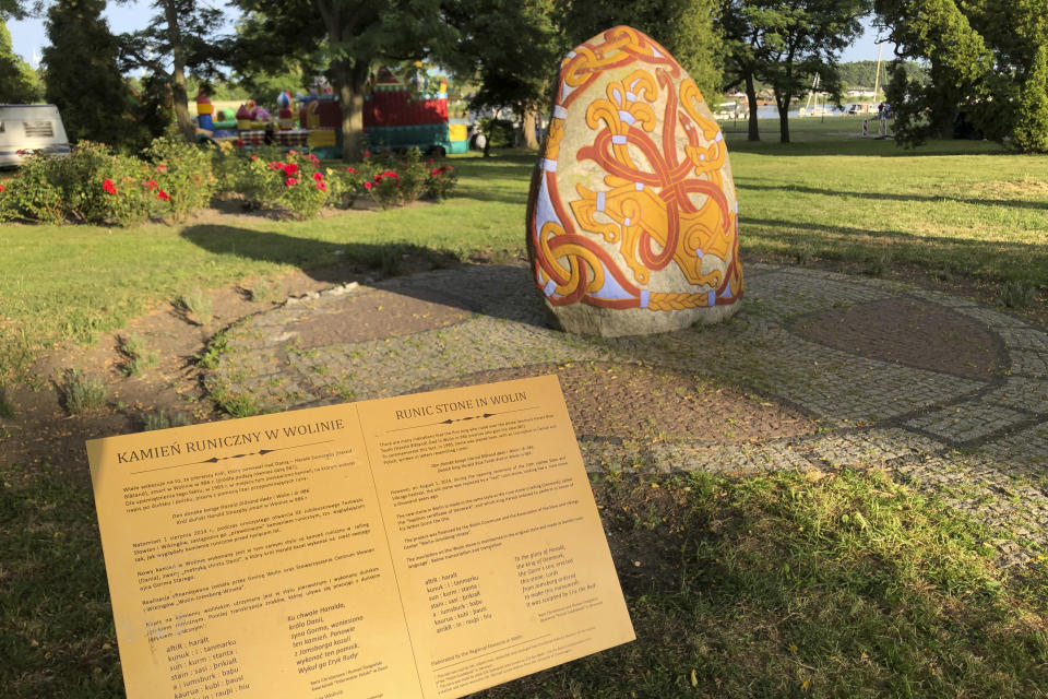 A view of a 2014 stone with runic inscription in memory of Danish 10th century King Harald “Bluetooth” Gormsson, in Wolin, Poland, Saturday, July 30,2022. More than 1,000 years after his death in what is now Poland, a Danish king whose nickname is known to the world through the Bluetooth technology is at the center of an archeological dispute. A Polish researcher and a Swedish archeologist claim that they have pinpointed the probable burial site for King Harald Bluetooth Gormsson in a small village in northwestern Poland, an area that once had ties with the Vikings. (AP Photo Monika Scislowska)