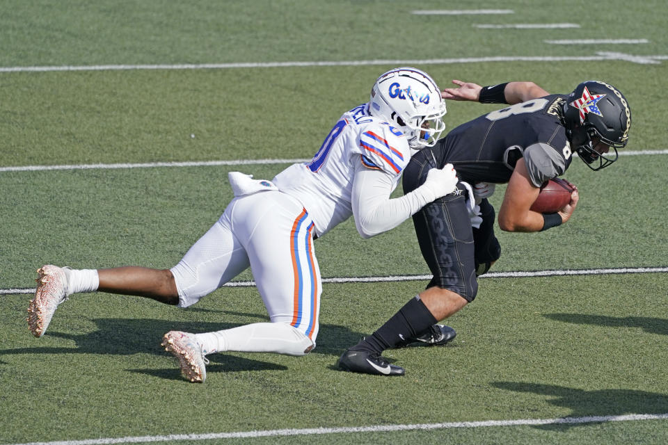 Florida linebacker Andrew Chatfield Jr. (10) brings down Vanderbilt quarterback Ken Seals (8) in the first half of an NCAA college football game Saturday, Nov. 21, 2020, in Nashville, Tenn. (AP Photo/Mark Humphrey)