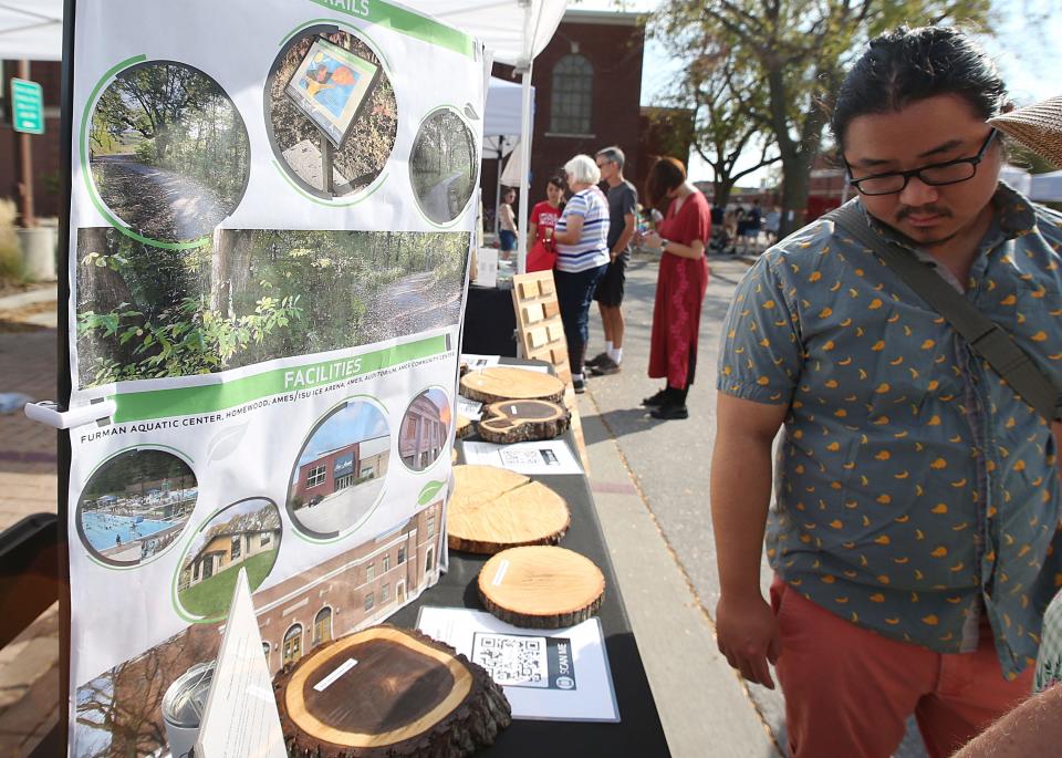 People look around the City of Ames' Park and Recreation department displays at Ames Eco Fair in the Ames City Hall Parking on Saturday, Sept. 30, 2023, in Ames, Iowa.