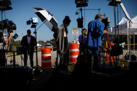 Members of the media broadcast from the street, close to the campus of Marjory Stoneman Douglas High School, following a mass shooting in Parkland, Florida, U.S., February 17, 2018. REUTERS/Carlos Garcia Rawlins