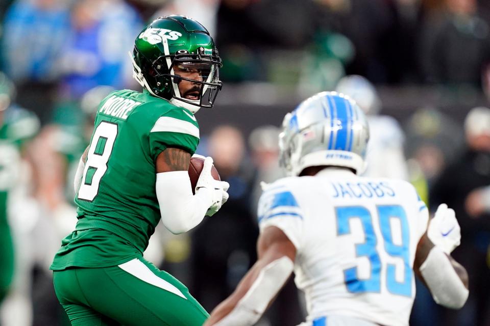 New York Jets wide receiver Elijah Moore makes a catch with pressure from Detroit Lions cornerback Jerry Jacobs in the second half, at MetLife Stadium on Sunday, Dec. 18, 2022.