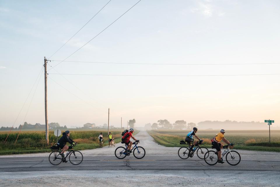 Cyclists pass near Carroll, Iowa, in July 2023. Safe Streets and Roads for All grant recipients must pay 20% of project costs, but Iowa and Kansas are covering that for rural and underserved communities. The transportation department wants other states to follow suit.