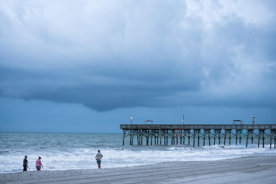 People walk along the beach in the morning August 3, 2020, in Myrtle Beach, South Carolina. / Credit: Sean Rayford / Getty Images