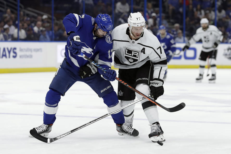 Los Angeles Kings center Jeff Carter (77) knocks the puck away from Tampa Bay Lightning left wing Alex Killorn (17) during the first period of an NHL hockey game Tuesday, Jan. 14, 2020, in Tampa, Fla. (AP Photo/Chris O'Meara)