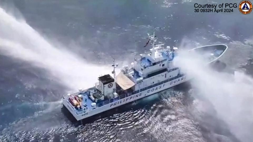 This frame grab from handout video footage taken and released on April 30, 2024 by the Philippine Coast Guard (PCG) shows the Philippine Coast Guard ship BRP Bagacay being hit by water cannon from Chinese coast guard vessels near the chinese-controlled Scarborough shoal in disputed waters of the South China Sea (Philippine Coast Guard (PCG)/AFP)
