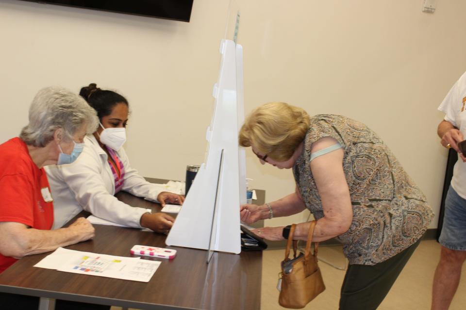 Anderson County Election Commission poll workers Linda Weaver, left, and Vidya Barnes, center, helped voter Linda Wilson, far right, sign in at the Oak Ridge Senior Center for the Aug. 4 county general election and state and federal primaries.