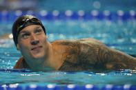 Caeleb Dressel reacts after winning the men's 50 freestyle during wave 2 of the U.S. Olympic Swim Trials on Sunday, June 20, 2021, in Omaha, Neb. (AP Photo/Jeff Roberson)