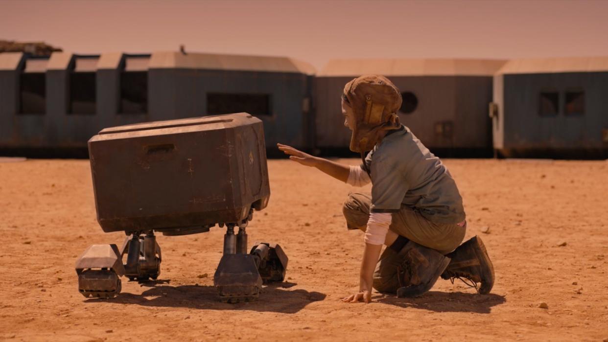 Young Remmy (Brooklynn Prince) makes a friend with a robot in the sci-fi drama "Settlers."