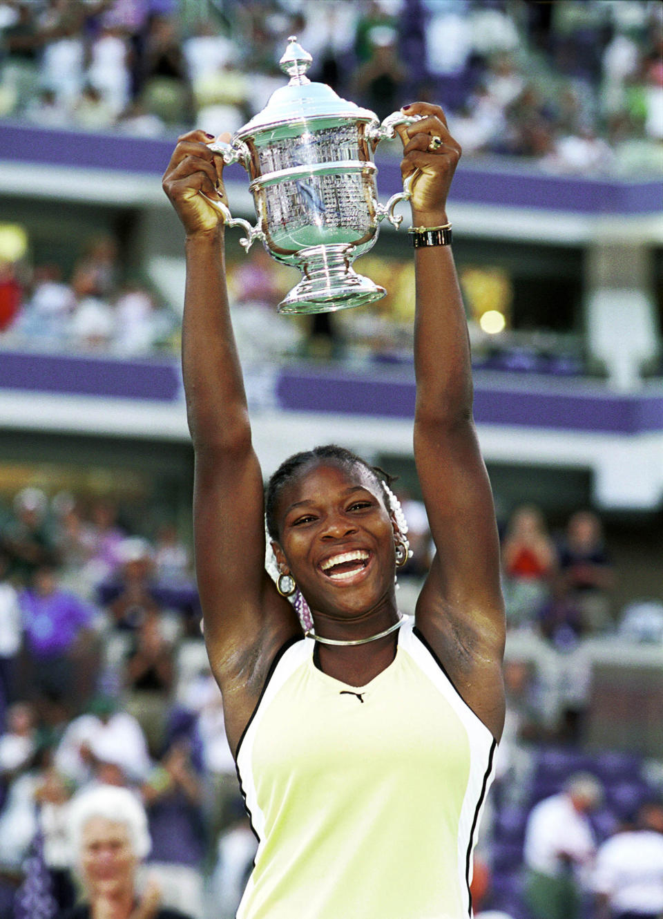 Serena raises the 1999 U.S. Open championship trophy, her first major win. She was 17<span class="copyright">Ron C. Angle—Getty Images</span>