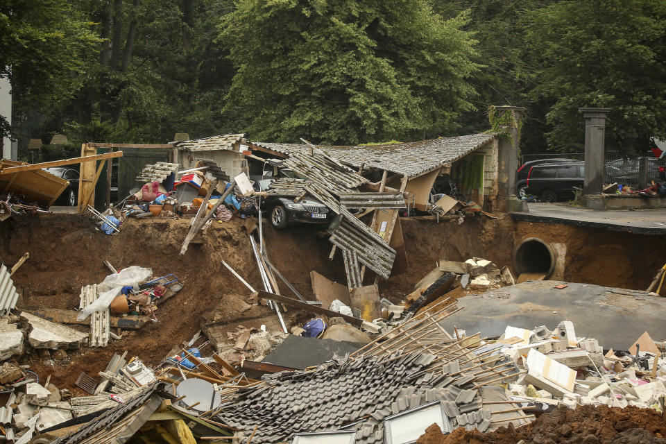 FILE - In this Friday, July 16, 2021 file photo, debris is strewn in the Blessem district of Erftstadt, Germany, after heavy rains caused mudslides and flooding in the western part of Germany. On Friday, July 23, 2021, The Associated Press reported on stories circulating online incorrectly asserting a manipulated photo shows a BMW car caught in floodwaters with anti-Greta Thunberg sticker on its rear window. But photojournalist David Young, who captured the original, unaltered photo for the German media outlet Bild in the city of Wuppertal, says, “It is my photo and it has been manipulated. … The sticker is fake.” (David Young/dpa via AP, File)