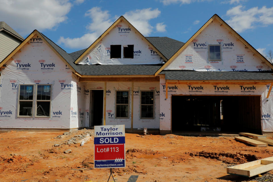 A home under construction stands behind a 