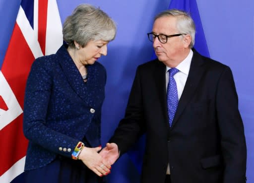 May (L), with European commission President Jean-Claude Juncker, twice delayed Britain's exit from the European Union